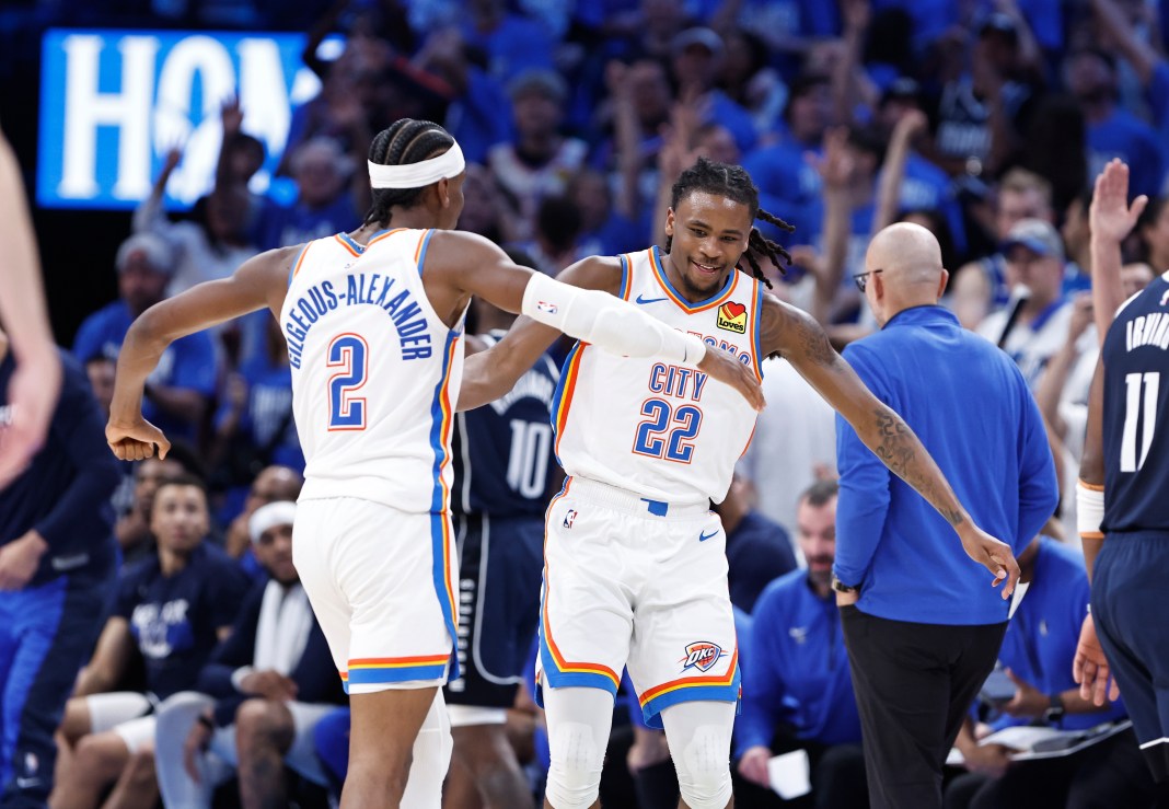 Oklahoma City Thunder guard Cason Wallace celebrates with Shai Gilgeous-Alexander after he scores a basket against the Dallas Mavericks.