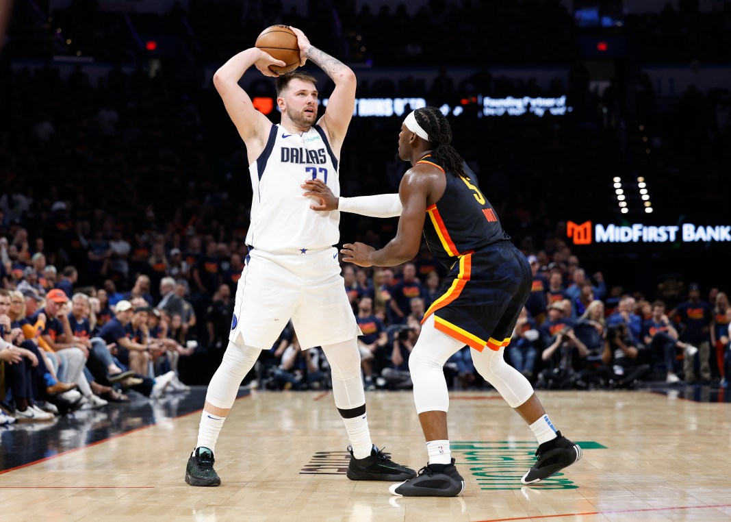 Oklahoma City Thunder guard Luguentz Dort (5) defends a pass by Dallas Mavericks guard Luka Doncic (77) during the second half of game five of the second round for the 2024 NBA playoffs at Paycom Center