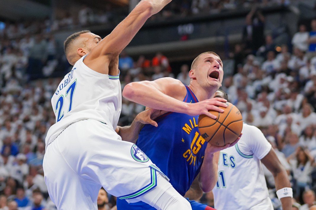 Denver Nuggets center Nikola Jokic (15) shoots against the Minnesota Timberwolves center Rudy Gobert (27)