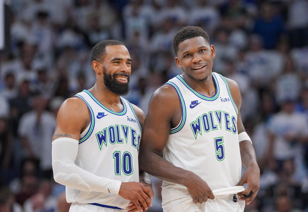 Minnesota Timberwolves players Mike Conley Jr. and Anthony Edwards chat during the NBA Playoffs.