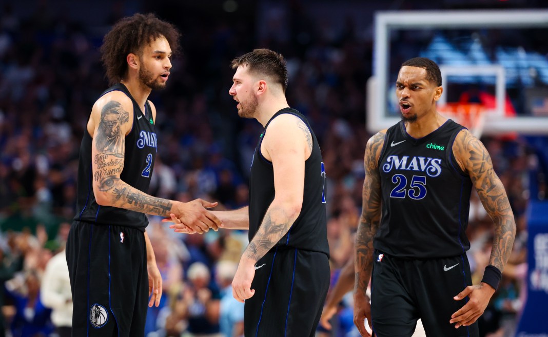 Dallas Mavericks guard Luka Doncic (77) celebrates with Dallas Mavericks center Dereck Lively II (2) and Dallas Mavericks forward P.J. Washington (25) against the Oklahoma City Thunder