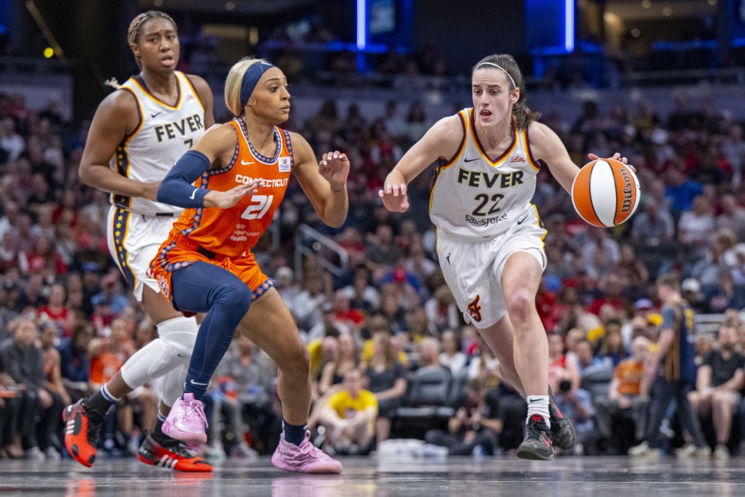 caitlin clark dribbles the ball