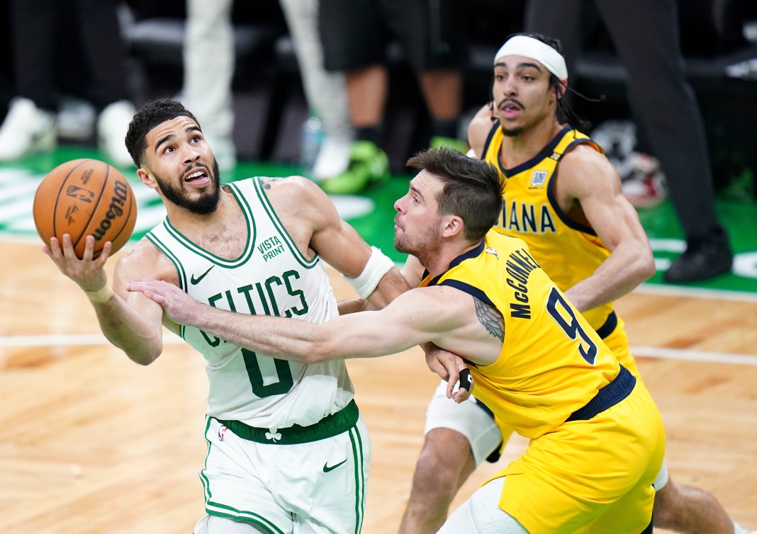 Pacers guard T.J. McConnell defends against Celtics' Jayson Tatum in the 2024 NBA playoffs.