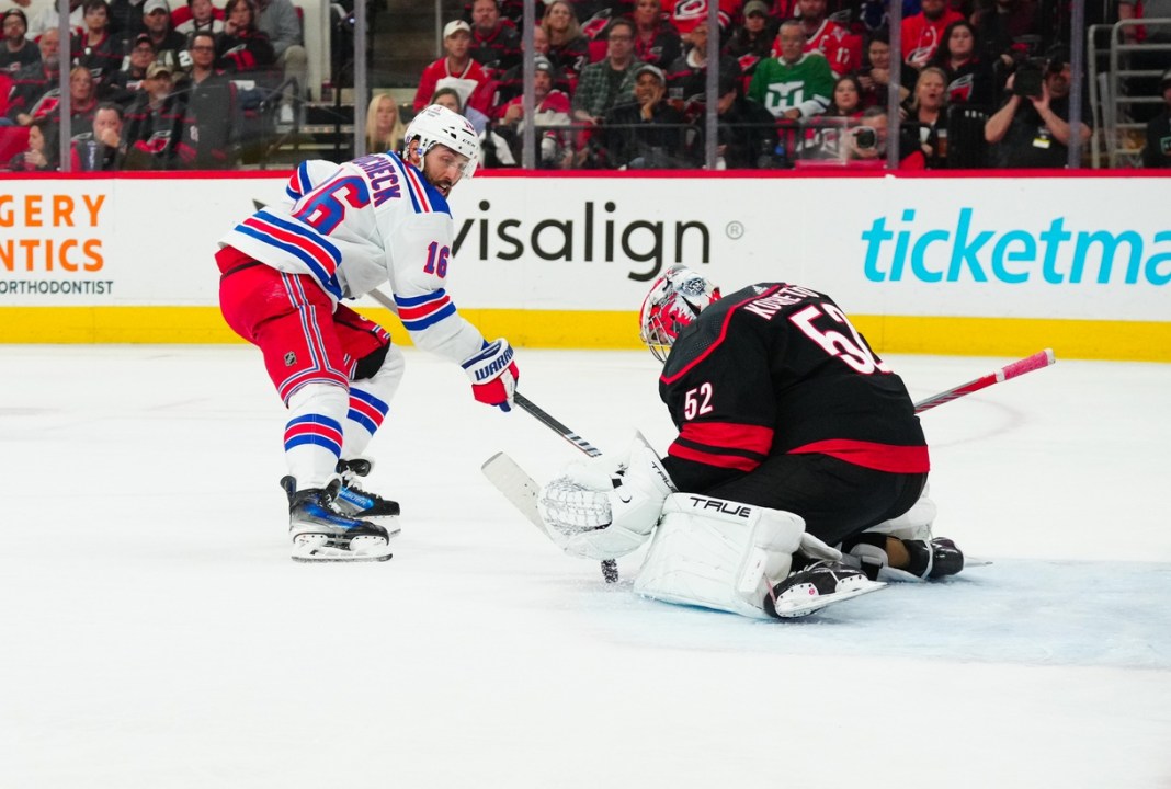 Carolina Hurricanes goaltender Pyotr Kochetkov (52) stops the scoring attempt by New York Rangers center Vincent Trocheck (16)