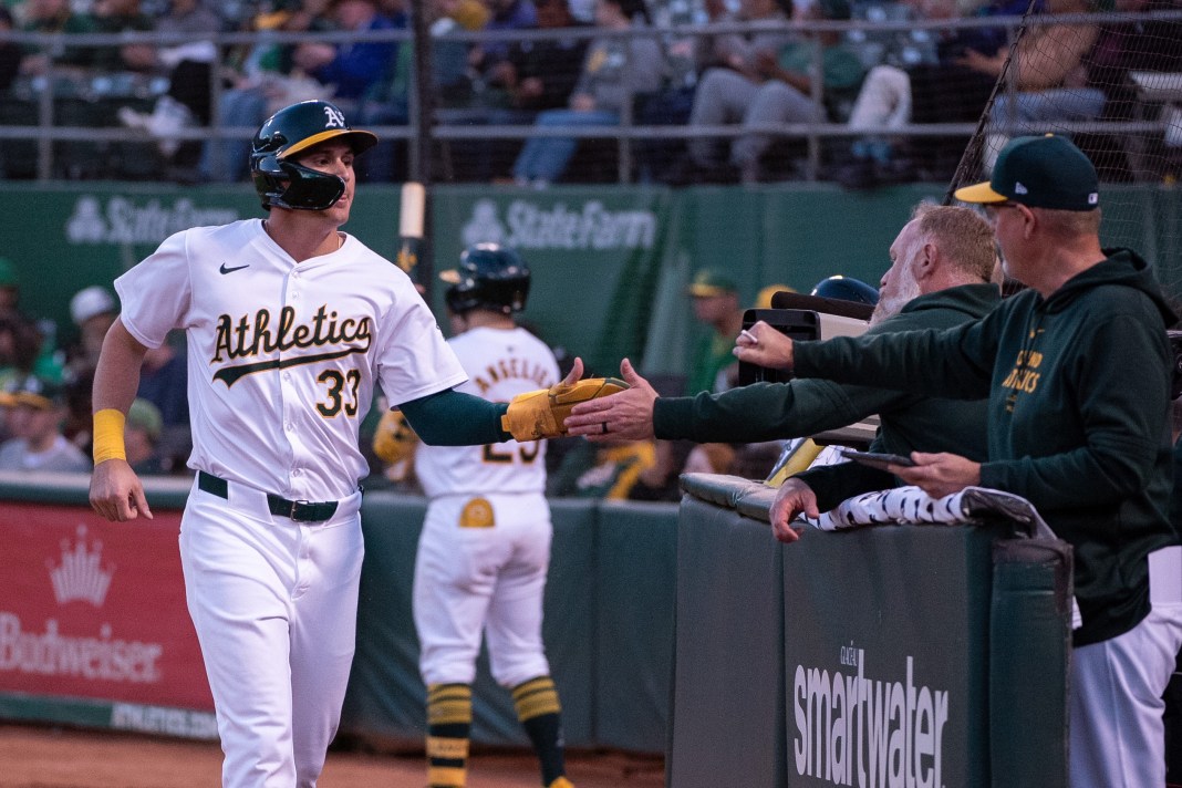 Oakland Athletics outfielder JJ Bleday celebrates with team mates after scoring against the Colorado Rockies.