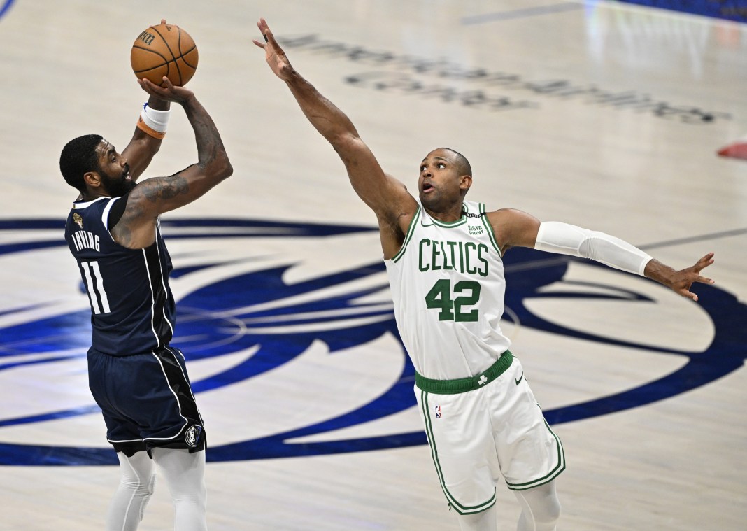 Mavericks' Kyrie Irving shoots against Celtics' Al Horford in the 2024 NBA Finals.