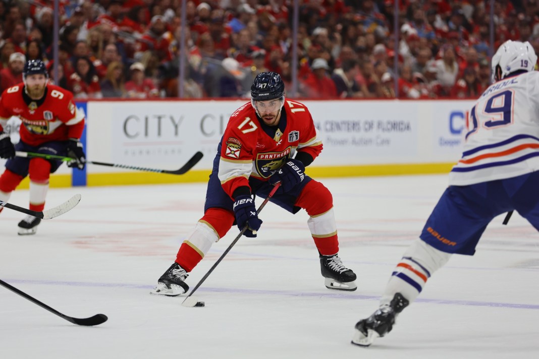 Florida Panthers forward Evan Rodrigues (17) skates with the puck against Edmonton Oilers forward Adam Henrique (19) during the second period in game two of the 2024 Stanley Cup Final