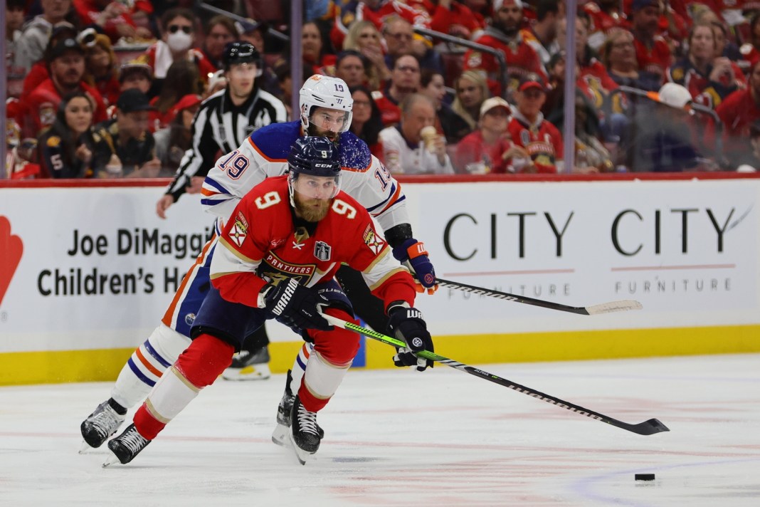 Florida Panthers forward Sam Bennett (9) controls the puck against Edmonton Oilers forward Adam Henrique (19)