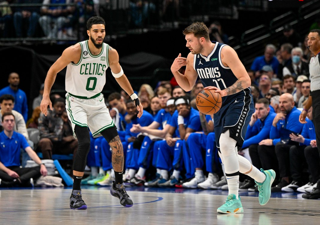 Celtics' Jayson Tatum and Mavericks' Luka Doncic in action during a game at the American Airlines Center.