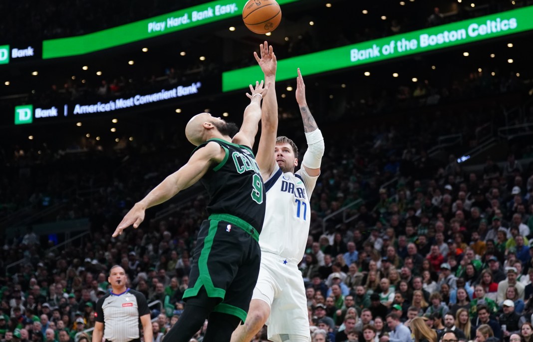 Dallas Mavericks guard Luka Doncic shoots against Boston Celtics guard Derrick White in the first quarter at TD Garden.