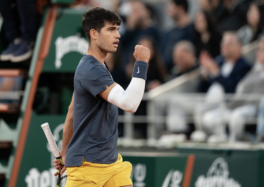 Carlos Alcaraz celebrates winning a big point against Stefanos Tsitsipas in the French Open quarterfinals.