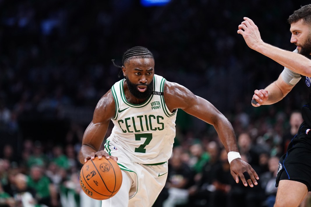 Celtics' Jaylen Brown controls the ball against Mavericks' Maxi Kleber in the 2024 NBA Finals.