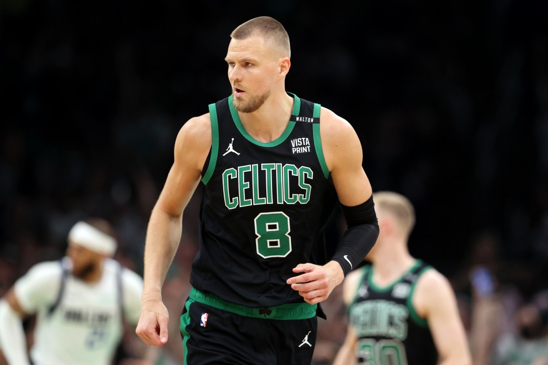 Celtics' Kristaps Porzingis reacts after a play against the Mavericks.