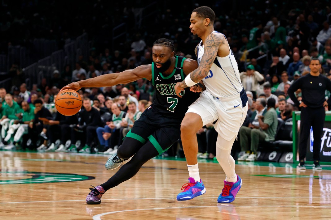 Celtics' Jaylen Brown dribbles against Mavericks' P.J. Washington in the 2024 NBA Finals.