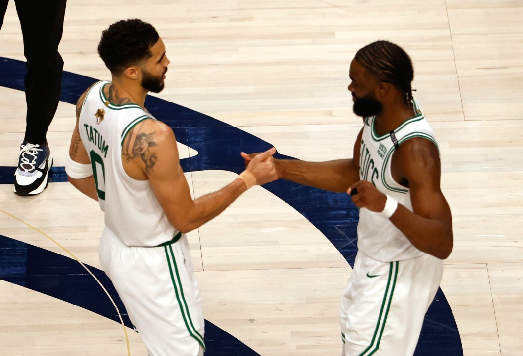 Celtics' Jayson Tatum and Jaylen Brown celebrate after defeating Mavericks in the 2024 NBA Finals.