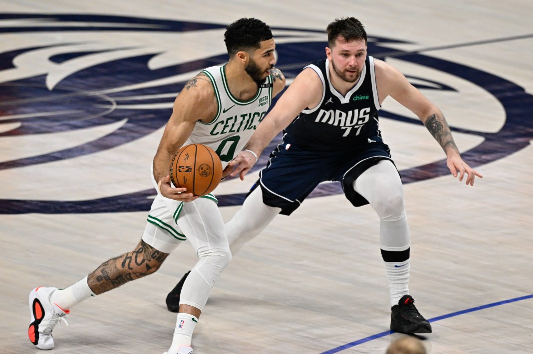 Celtics' Jayson Tatum dribbles against Mavericks' Luka Doncic in the 2024 NBA Finals.