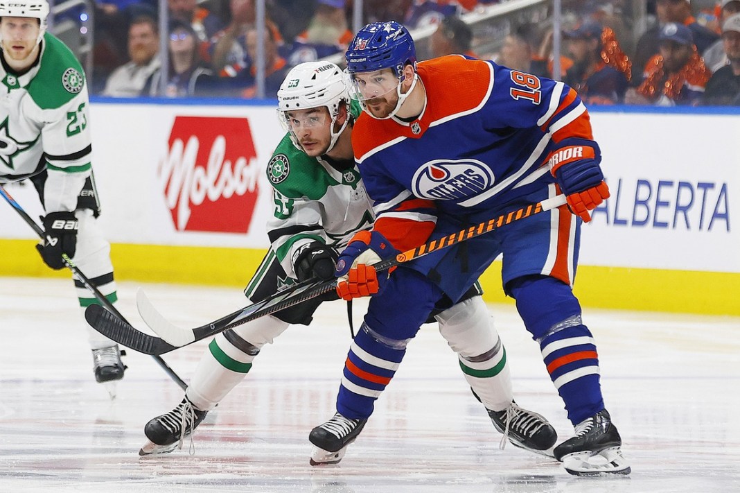 Edmonton Oilers forward Zach Hyman and Dallas Stars forward Wyatt Johnson battle for position during the 2024 Stanley Cup Playoffse.