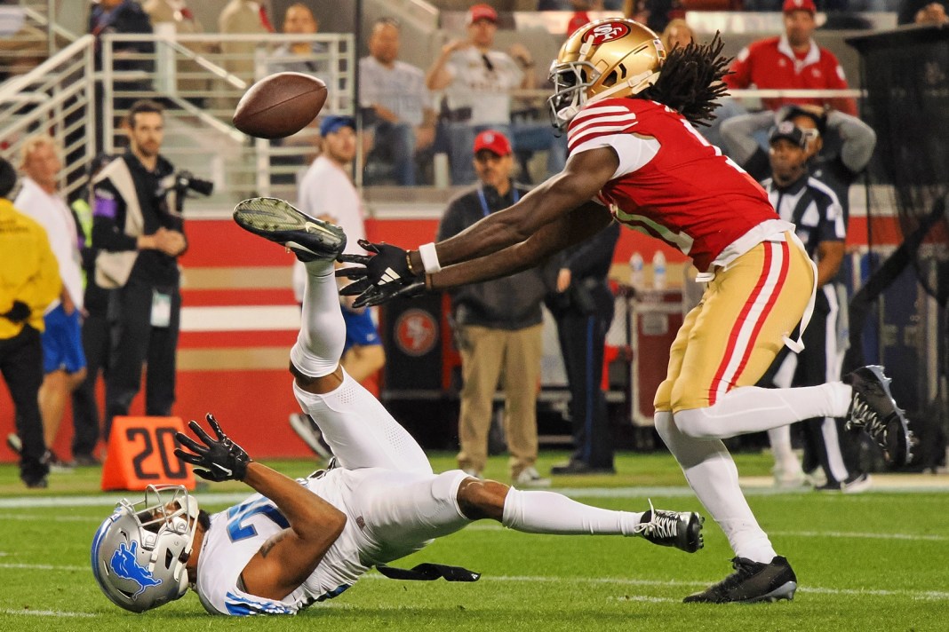 San Francisco 49ers wide receiver Brandon Aiyuk (11) reaches for a ball that bounced off the face mask of Detroit Lions cornerback Kindle Vildor (29)