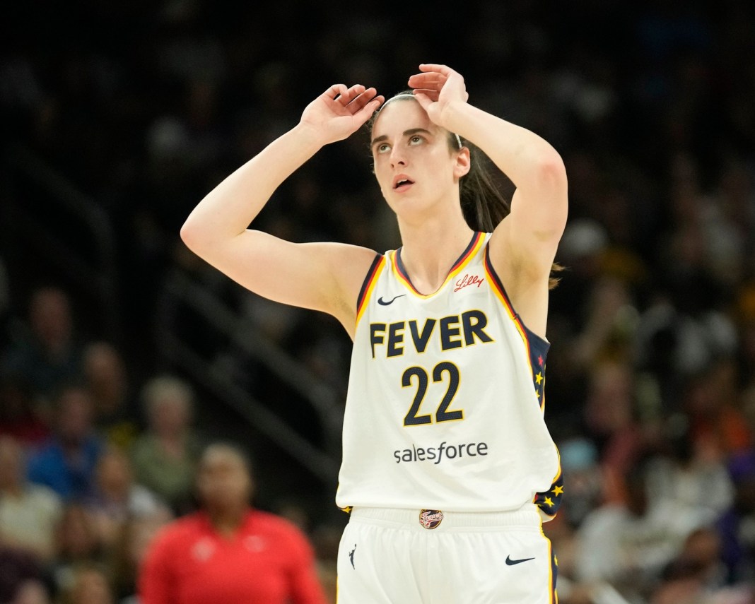 Indiana Fever guard Caitlin Clark (22) adjusts her headband during the first quarter against the Phoenix Mercury at Footprint Center