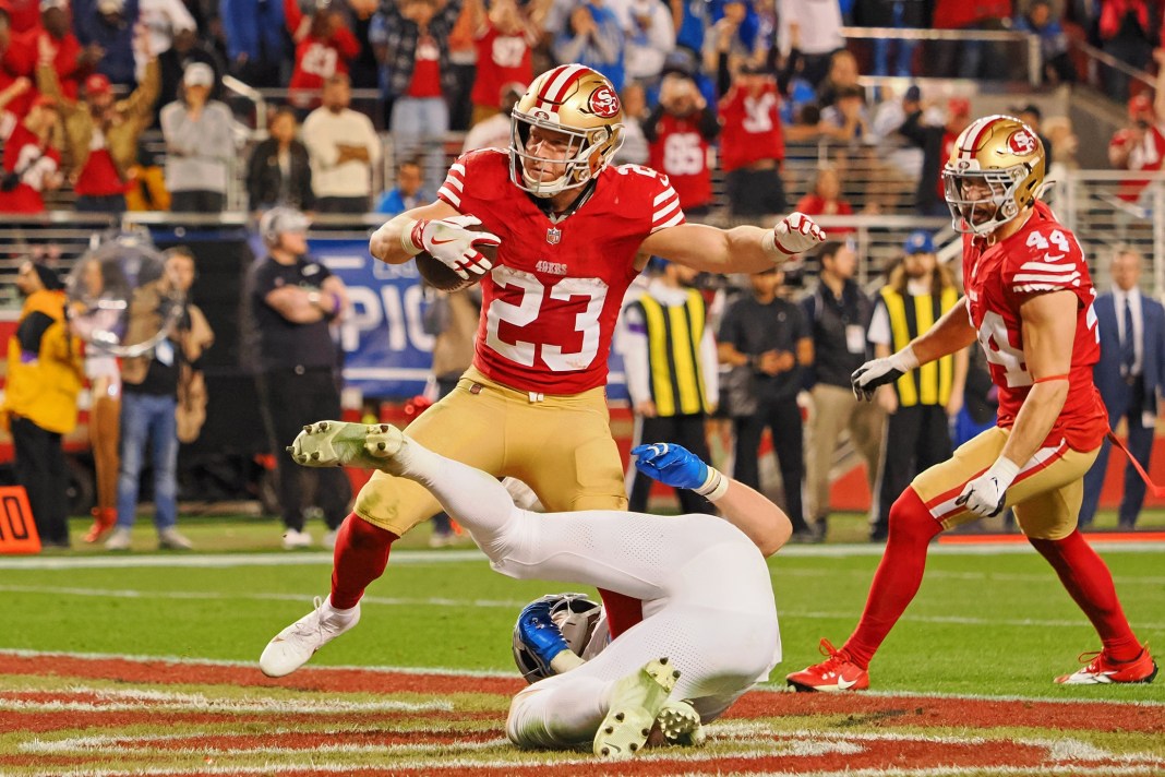 San Francisco 49ers running back Christian McCaffrey (23) runs with the ball for a touchdown against the Detroit Lions during the second half of the NFC Championship football game at Levi's Stadium