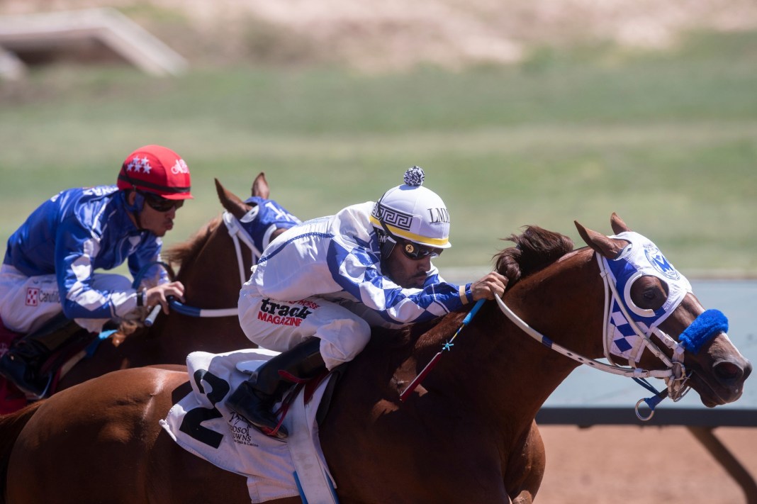 Horse jockey Luis M. Martinez races All Timefav in the Quarter Horse Allowance at Ruidoso Downs Race Track and Casino