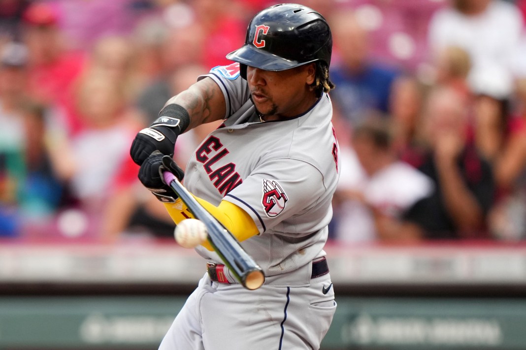 Cleveland Guardians third baseman Jose Ramirez (11) hits a double in the first inning of a baseball game against the Cincinnati Reds