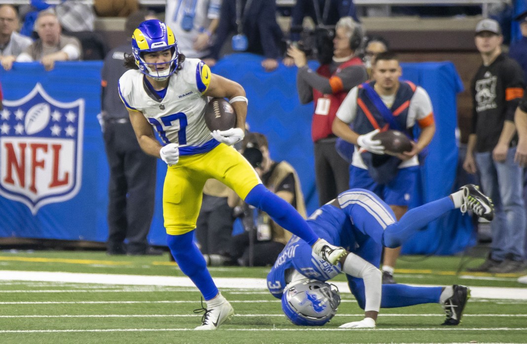 Los Angeles Rams wide receiver Puka Nacua runs from Detroit Lions safety Kerby Joseph.