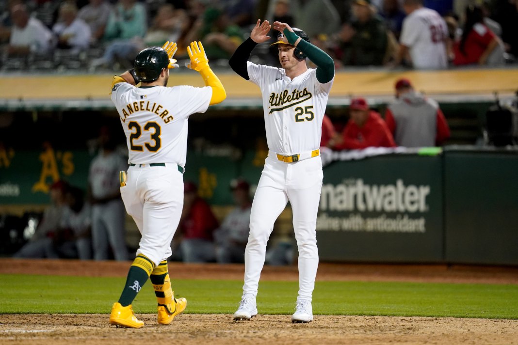 Oakland Athletics catcher Shea Laneliers (23) is congratulated by first baseman Seth Brown (15) after hitting a two-run home run against the Los Angeles Angels in the sixth inning at Oakland-Alameda County Coliseum.