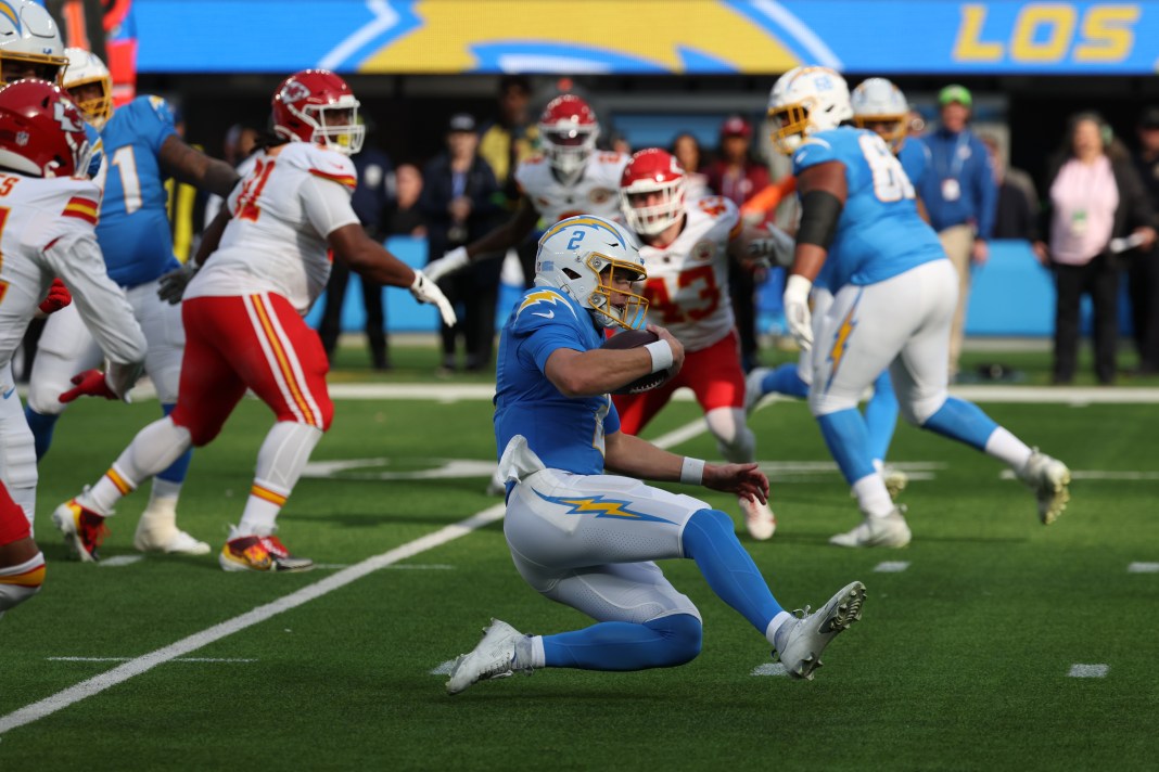 Los Angeles Chargers quarterback Easton Stick (2) slides for a first down during the first quarter against the Kansas City Chiefs at SoFi Stadium