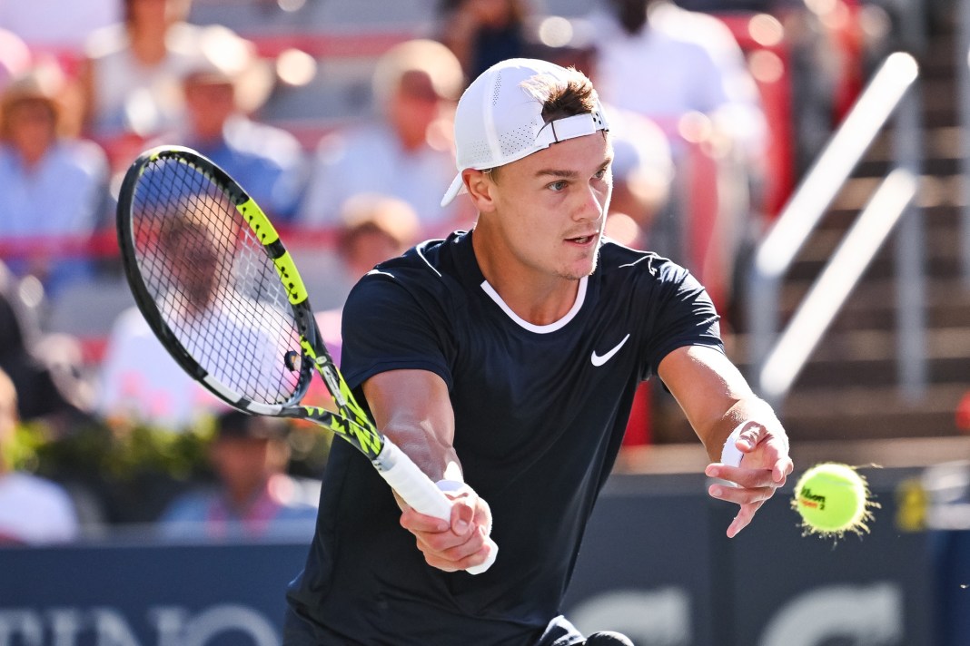 Holger Rune hits a volley in his match against Alexander Zverev at the National Bank Open in Montreal.