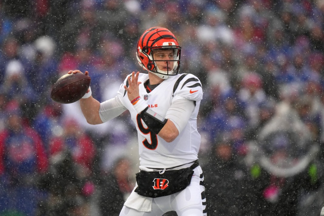 Cincinnati Bengals quarterback Joe Burrow throws a football during an NFL playoff football game.