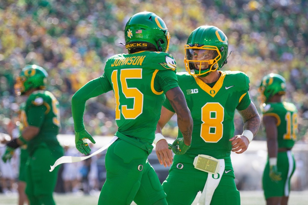 Dillon Gabriel celebrates with Tez Johnson after a touchdown scored by Oregon in a win over Idaho.