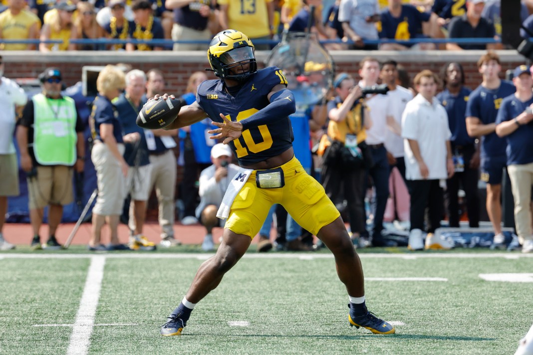 Michigan Wolverines quarterback Alex Orji throws against the Arkansas State Red Wolves during the second half at Michigan Stadium.