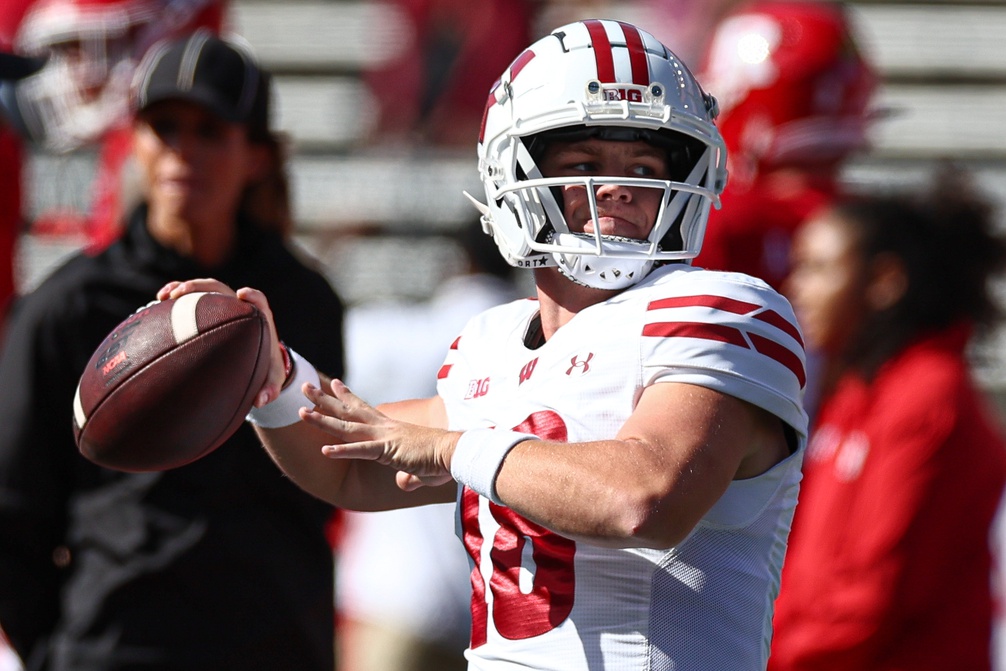 Wisconsin Badgers quarterback Braedyn Locke (18) warms up before the game against the Rutgers Scarlet Knights