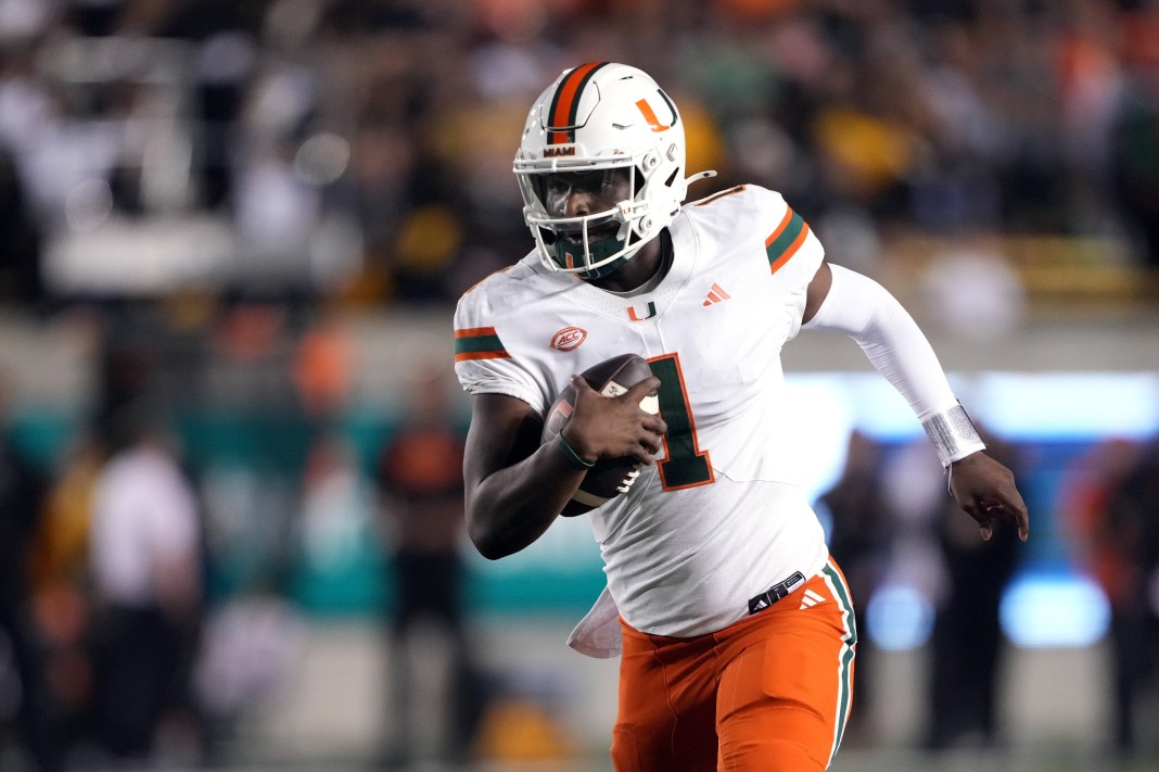 Miami Hurricanes quarterback Cam Ward (1) rushes for a touchdown /across the/ during the fourth quarter at California Memorial Stadium