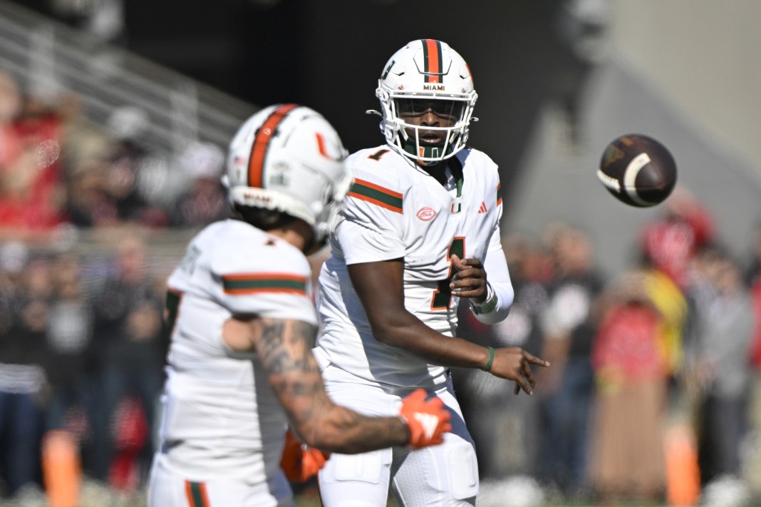 Miami Hurricanes quarterback Cam Ward (1) passes to wide receiver Xavier Restrepo (7) against the Louisville Cardinals