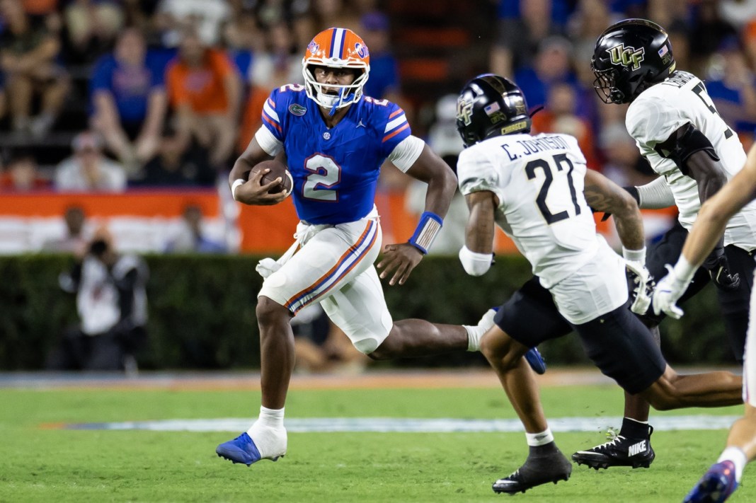 Florida Gators quarterback DJ Lagway (2) scrambles past UCF Knights defensive back Chasen Johnson (27) and UCF Knights defensive end Malachi Lawrence (51)