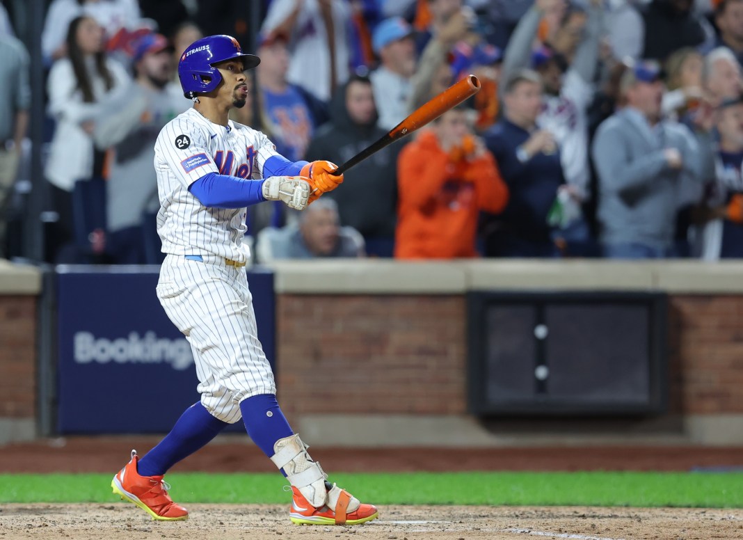 New York Mets shortstop Francisco Lindor (12) hits a grand slam against the Philadelphia Phillies in the sixth inning in game four of the NLDS for the 2024 MLB Playoffs at Citi Field