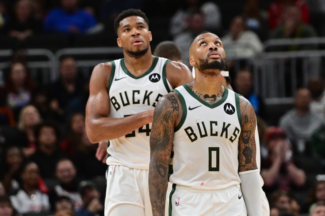 Milwaukee Bucks forward Giannis Antetokounmpo (34) and guard Damian Lillard (0) look on in the second quarter against the Chicago Bulls