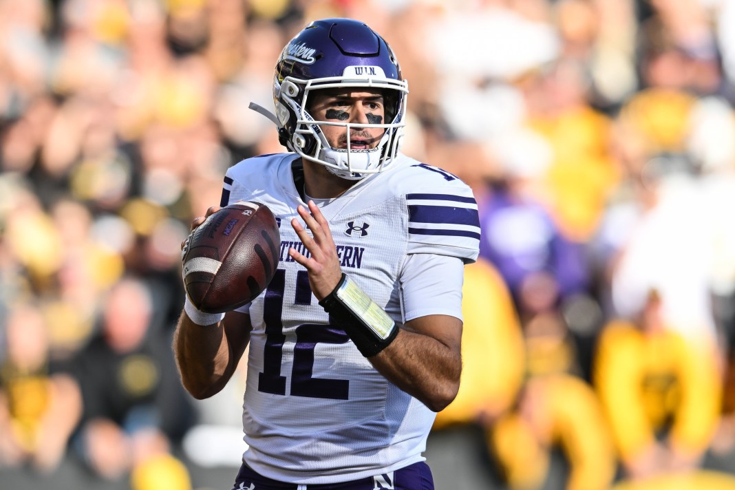 Northwestern Wildcats quarterback Jack Lausch drops back to throw a pass against the Iowa Hawkeyes.