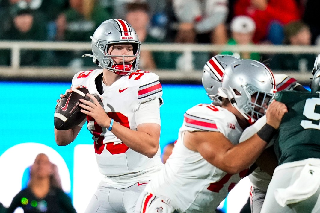 Ohio State Buckeyes quarterback Devin Brown looks to pass the ball in the second half at Spartan Stadium on Saturday.