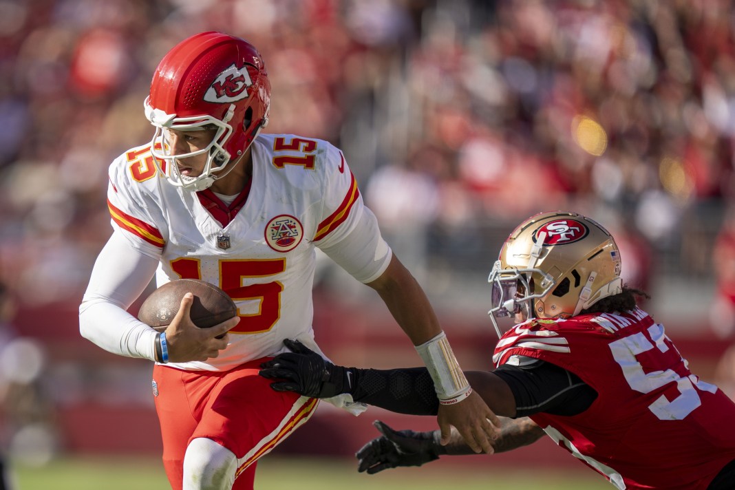 Kansas City Chiefs quarterback Patrick Mahomes (15) runs past San Francisco 49ers linebacker Dee Winters (53)