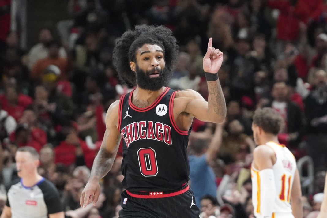 Bulls guard Coby White gestures after a made shot in a game against the Hawks.