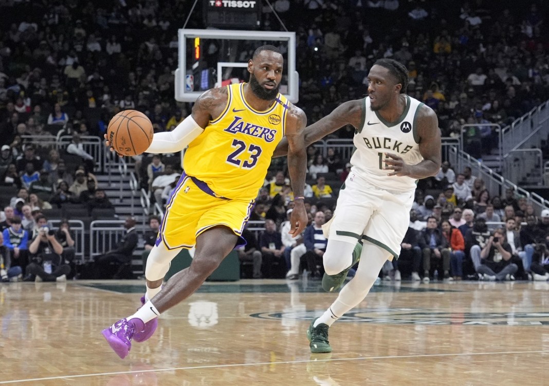 Lakers star LeBron James drives to the basket in a preseason game against the Bucks.