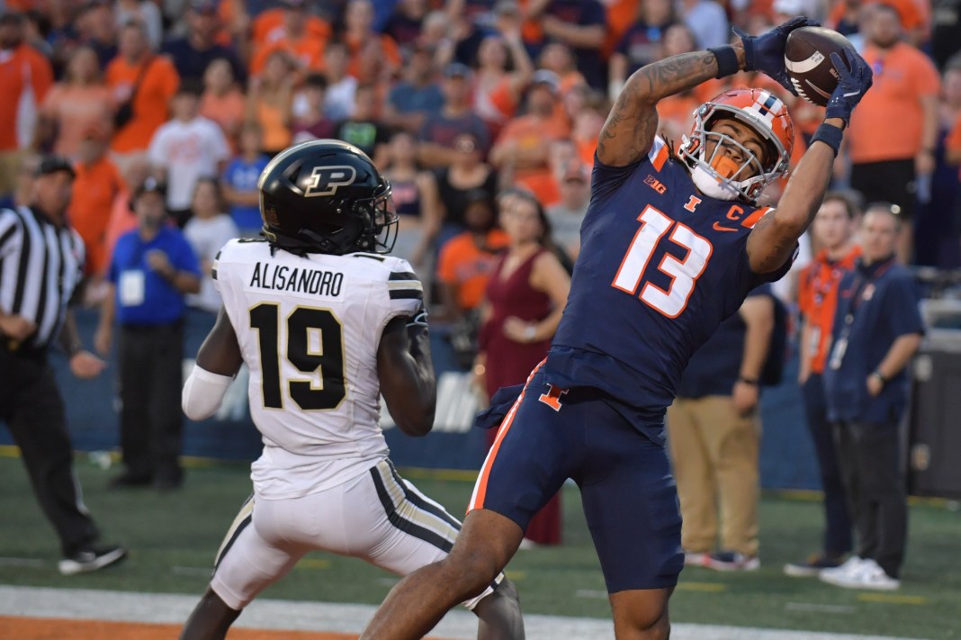 Illinois Fighting Illini wide receiver Pat Bryant (13) scores a touchdown catch over Purdue Boilermakers defensive back Botros Alisandro