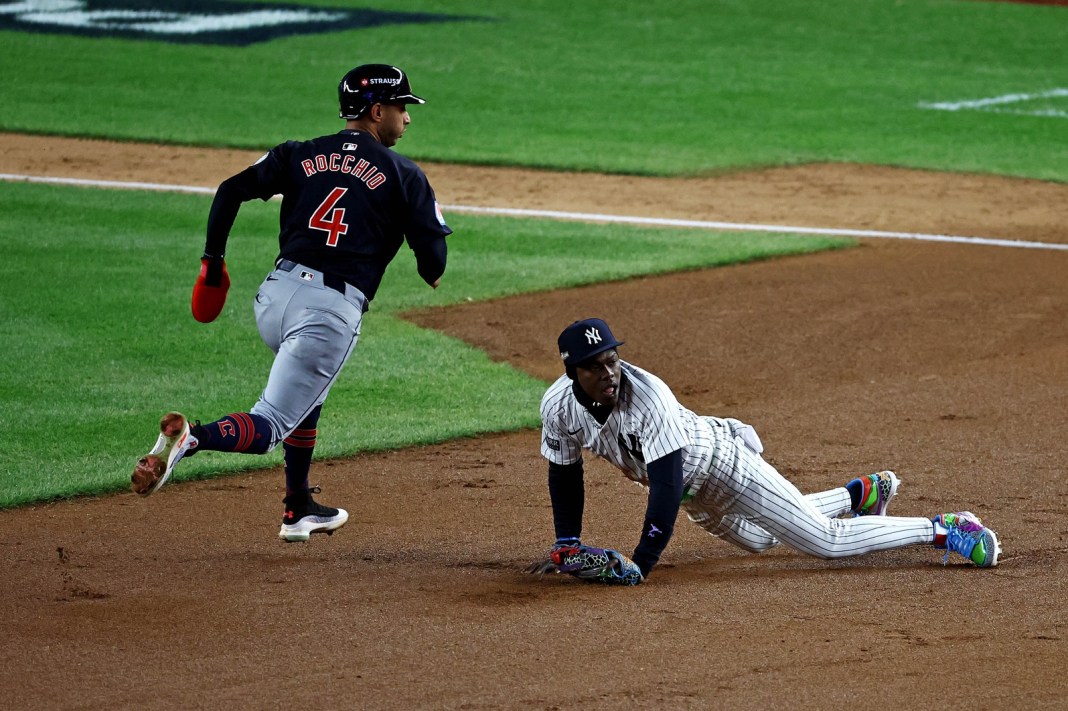 Cleveland Guardians shortstop Brayan Rocchio (4) runs around New York Yankees third base Jazz Chisholm Jr. (13) to score a run