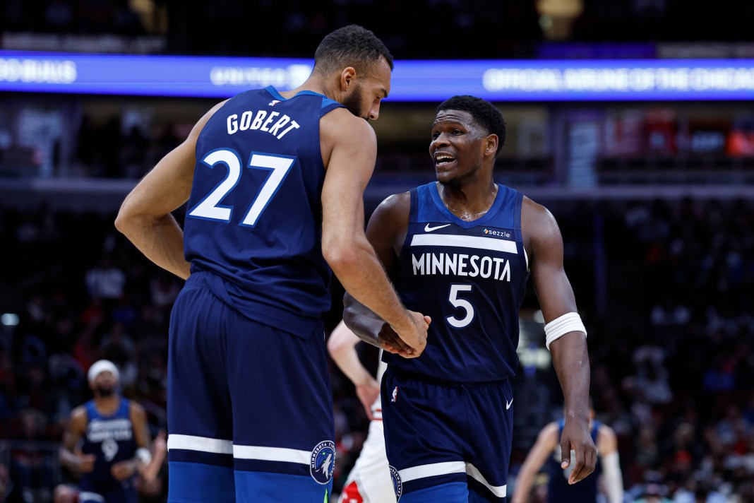 Minnesota Timberwolves center Rudy Gobert (27) reacts with guard Anthony Edwards (5) during the first half of an NBA game against the Chicago Bulls at United Center