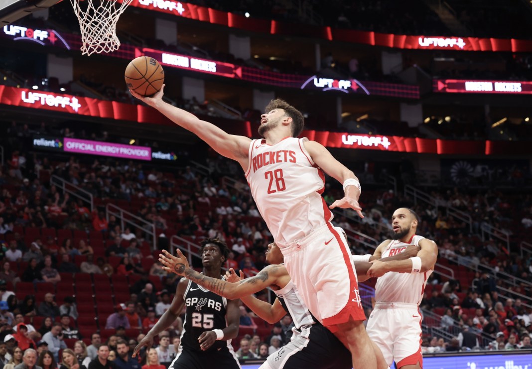 Rockets big man Alperen Sengun takes a shot against the Spurs in a preseason game.