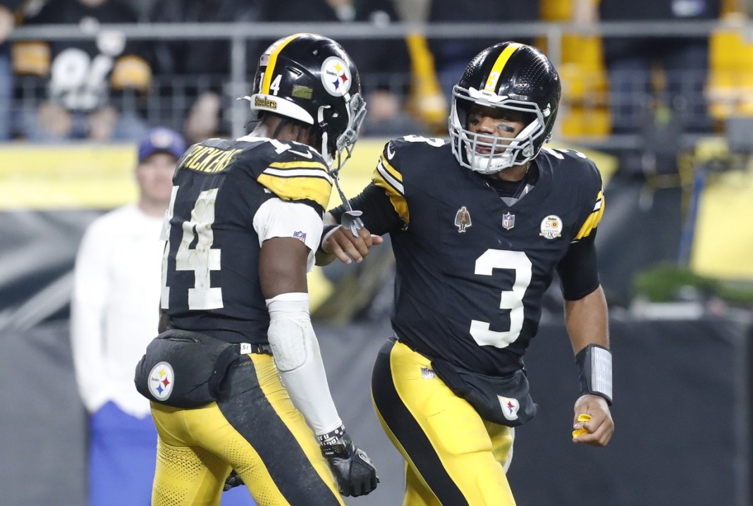 Steelers players Russell Wilson and George Pickens react to a big play against the Jets in Week 7 of the 2024 NFL season.