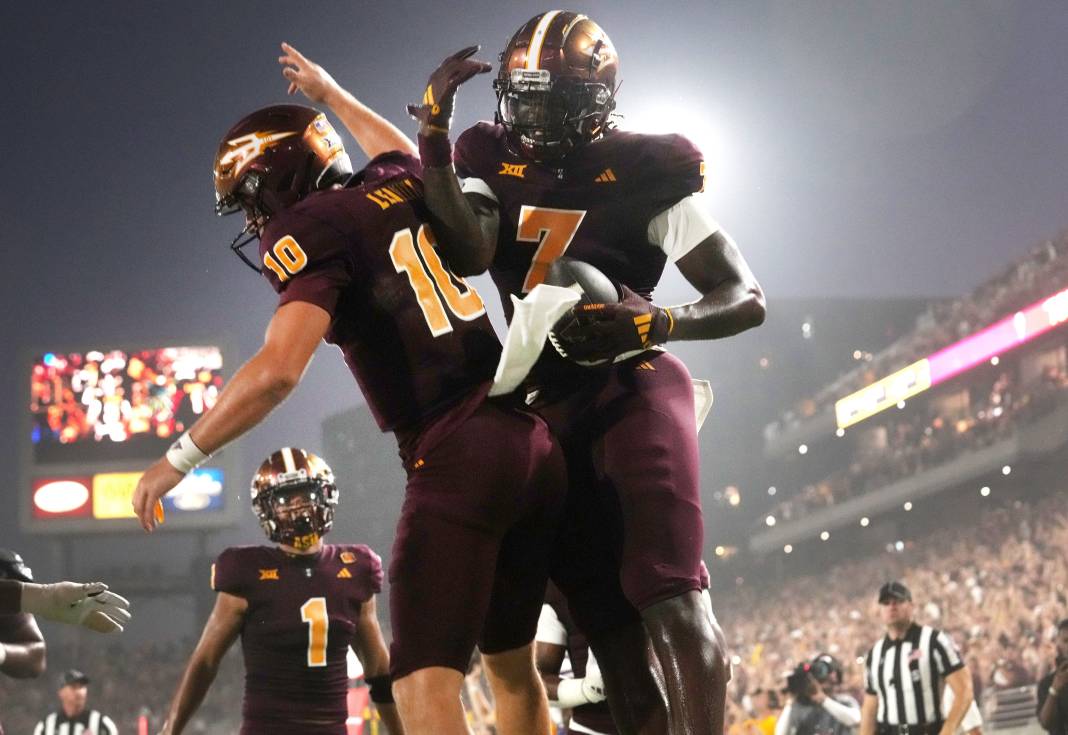 Arizona State quarterback Sam Leavitt (10) celebrates his touchdown pass to tight end Chamon Metayer (7) against the Kansas Jayhawks at Mountain America Stadium in Tempe